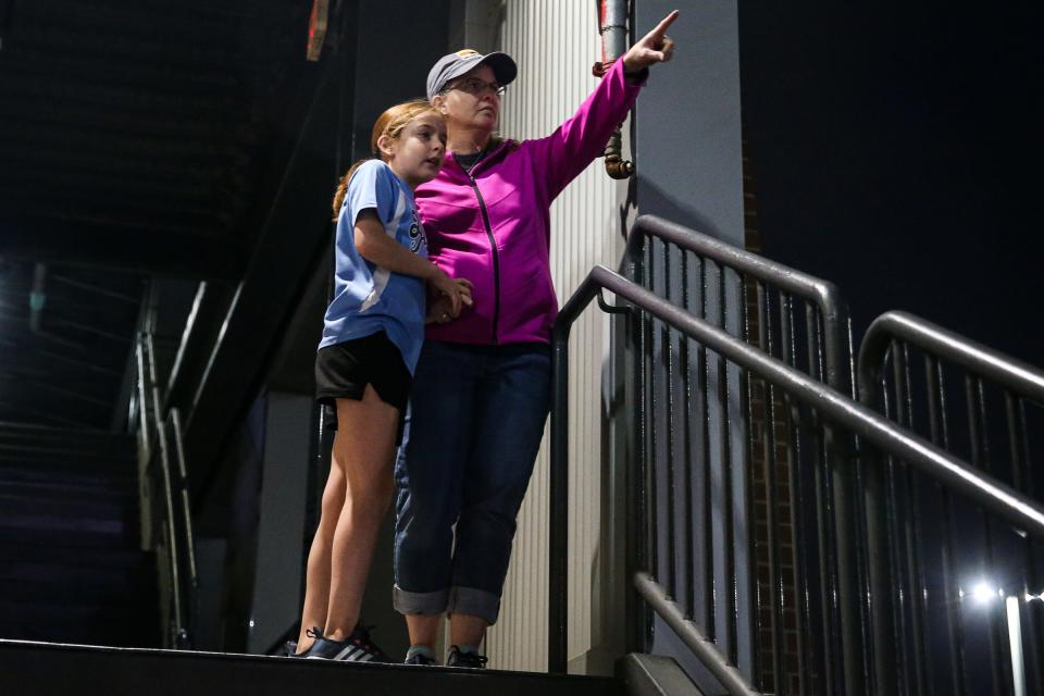 Alissa and Maya Gonzalez, 9, look at a crane that caught fire while working the new Harbor Bridge project on Saturday, April 22, 2023, in Corpus Christi, Texas. Alissa Gonzalez said they were watching a Hooks game at Whataburger Field when they "heard a big sound, like an airplane flew over the stadium."