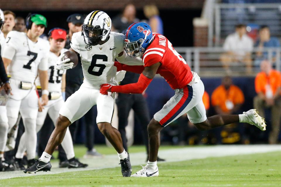 Oct 28, 2023; Oxford, Mississippi, USA; Vanderbilt Commodores wide receiver Jayden McGowan (6) runs with the ball after a catch as Mississippi Rebels defensive back Zamari Walton (6) makes the tackle during the first half at Vaught-Hemingway Stadium. Mandatory Credit: Petre Thomas-USA TODAY Sports