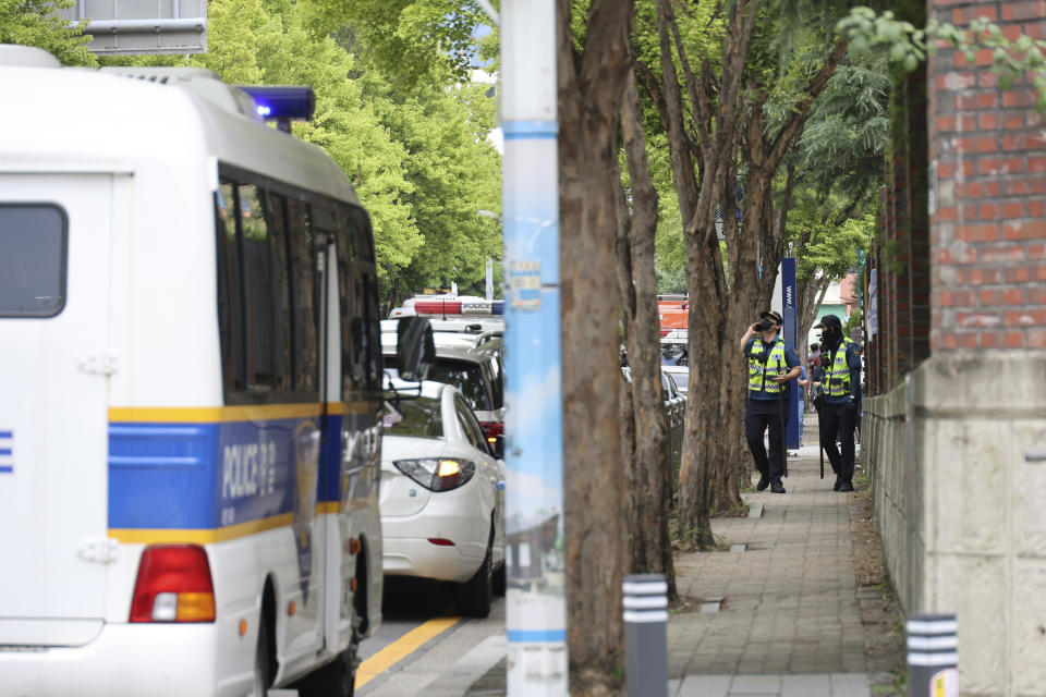 Police officers patrol around Songchon High School in Daejeon, South Korea, Friday, Aug. 4, 2023. South Korean police are chasing the suspect in a stabbing attack in at the high school in the central city of Daejeon, a day after another stabbing incident leaving multiple people wounded at a shopping mall in the city of Seongnam, south of Seoul on Thursday. (Kang Soo-hwan/Yonhap via AP)
