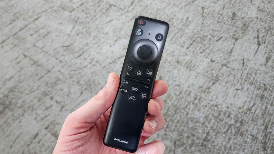 Samsung Q70C remote in hand