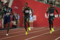 FILE - In this June 27, 2021, file photo, Noah Lyles, right, wins the final in the men's 200-meter run ahead of Kenny Bednarek, left, in second and Erriyon Knighton, in third, at the U.S. Olympic Track and Field Trials in Eugene, Ore. Lyles, the 200-meter world champion, will lead a strong contingent of American sprinters that includes teenager Knighton at the upcoming Tokyo Games. (AP Photo/Ashley Landis, File)