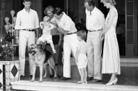 <p>While on vacation with Spain's King Juan Carlos and Queen Sofia, Prince Charles acquaints Prince Harry with the family dog.</p>