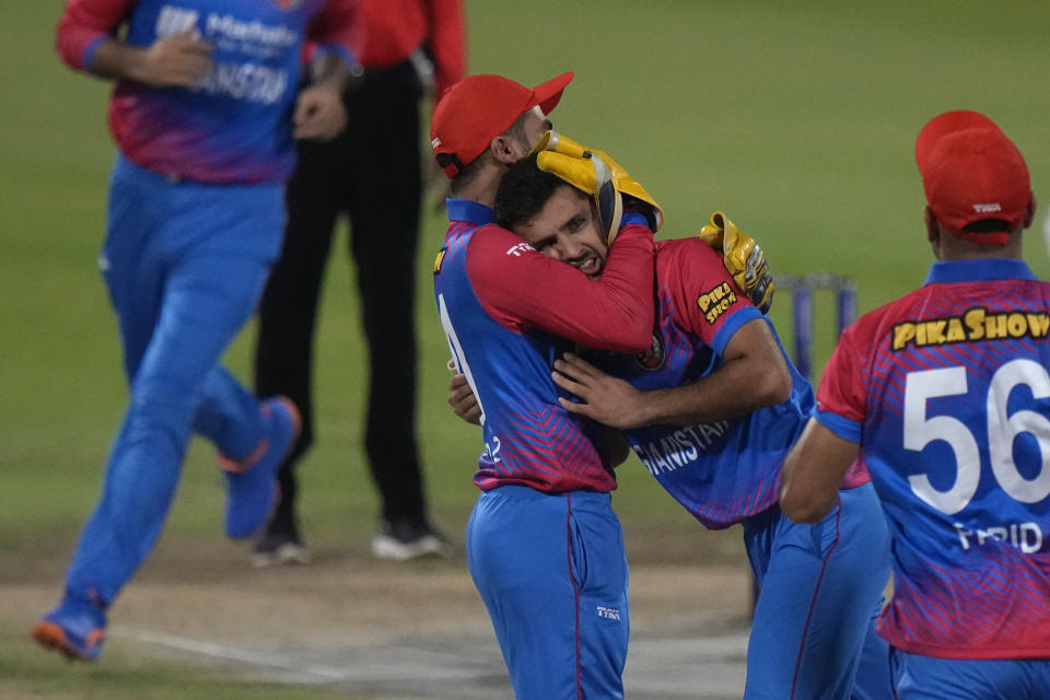 Afghanistan's Fazalhaq Farooqi, second right, celebrates with teammates the dismissal of Pakistan's captain Babar Azam during the T20 cricket match of Asia Cup between Pakistan and Afghanistan, in Sharjah, United Arab Emirates, Wednesday, Sept. 7, 2022. (AP Photo/Anjum Naveed)