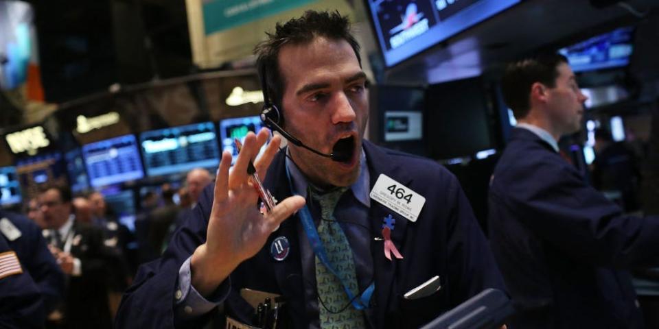 Traders work on the floor of The New York Stock Exchange