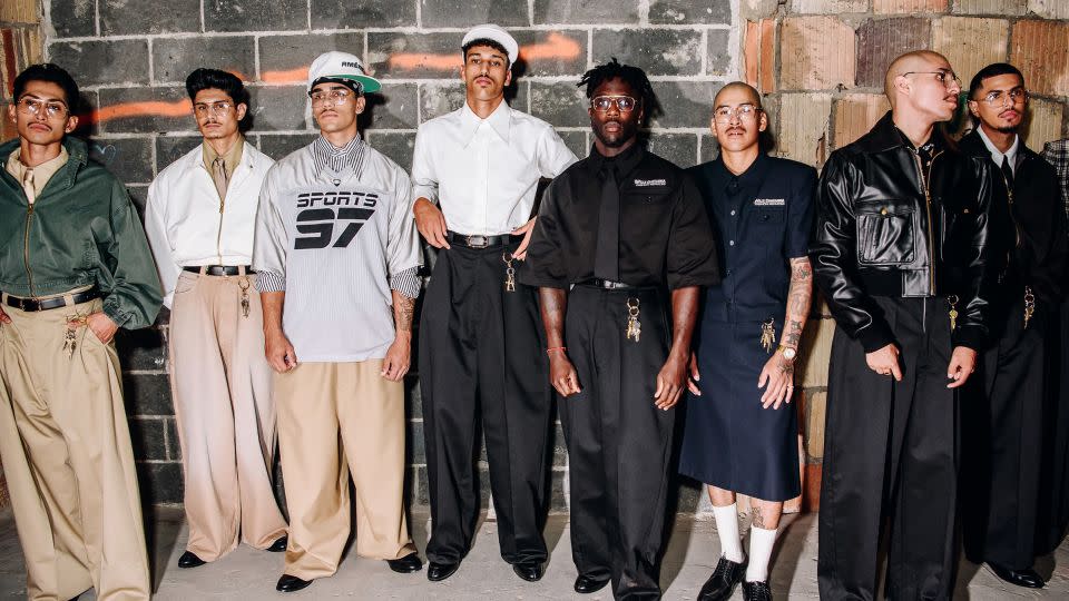 Models line up backstage at Willy Chavarria in wide, belted pants, starched tailoring and a bunch of dangling keys as accessories. - Nina Westervelt/WWD/Getty Images