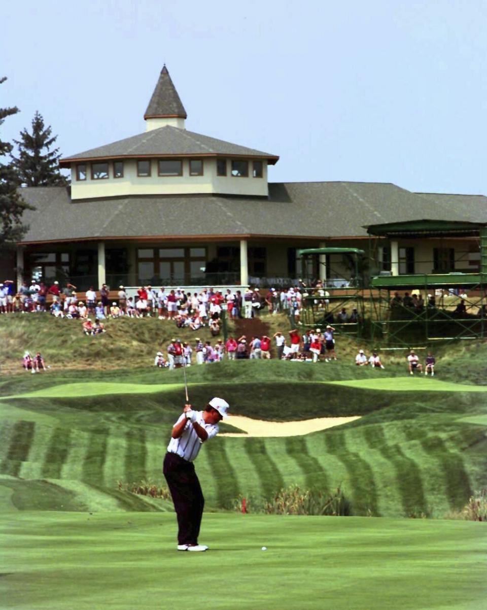 FILE - Kentucky native Kenny Perry hits an approach shot to the 18th green as the Valhalla Golf Club clubhouse looms in the background during a practice round Aug. 5, 1996, in Louisville, Ky. Valhalla is hosting the PGA Championship for the fourth time May 16-19, 2024. (AP Photo/Ed Reinke, File)