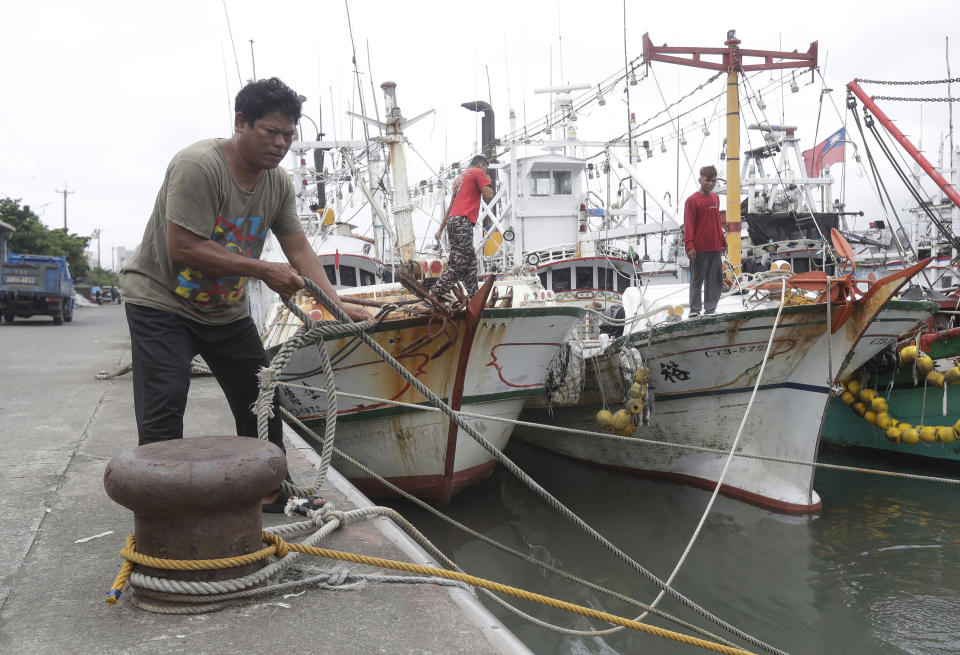 Fishermen fasten the boats as Typhoon Mawar approaches to Taiwan in Yilan County, eastern coast of Taiwan, Tuesday, May 30, 2023. Typhoon Mawar lashed Taiwan's eastern coast on Tuesday with wind, rains and large waves but largely skirted the island after giving a glancing blow to the northern Philippines. (AP Photo/Chiang Ying-ying)