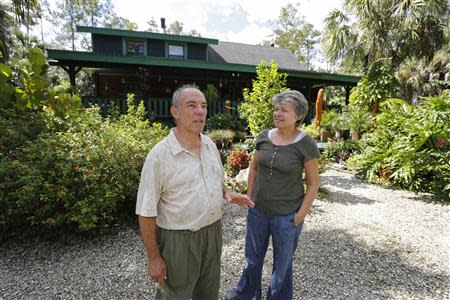 Jaime Duran and his wife Pamela stand in front of their home near proposed drilling locations in Naples, Florida September 21, 2013. REUTERS/Joe Skipper