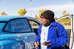 Denver resident learns how to use a free shuttle, serving as a micro transit connection to the regional transit system in the Montbello neighborhood, a high-transit need community.