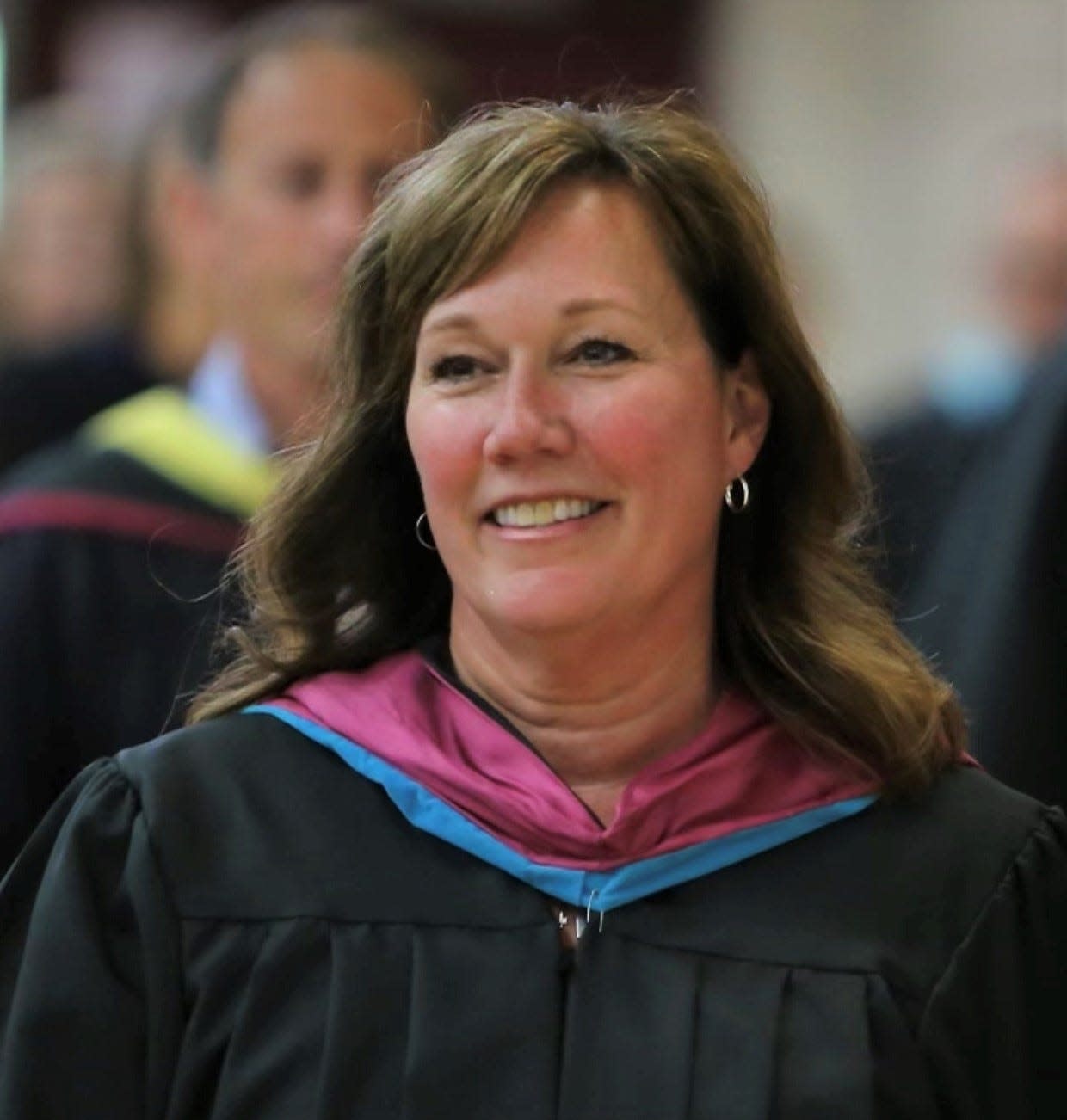 Suzanne Klinger smiles at the 2022 graduation ceremony. She is retiring after almost 30 years in the Charlevoix Public School system, the last 15 years being the principal for the Charlevoix Middle High School.