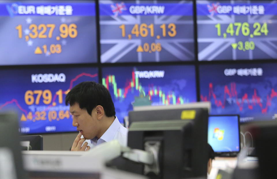 A currency trader watches monitors at the foreign exchange dealing room of the KEB Hana Bank headquarters in Seoul, South Korea, Tuesday, July 16, 2019. Asian shares were little changed and mixed in quiet trading Tuesday amid a lack of fresh market-moving news as investors looked ahead to earnings season. (AP Photo/Ahn Young-joon)