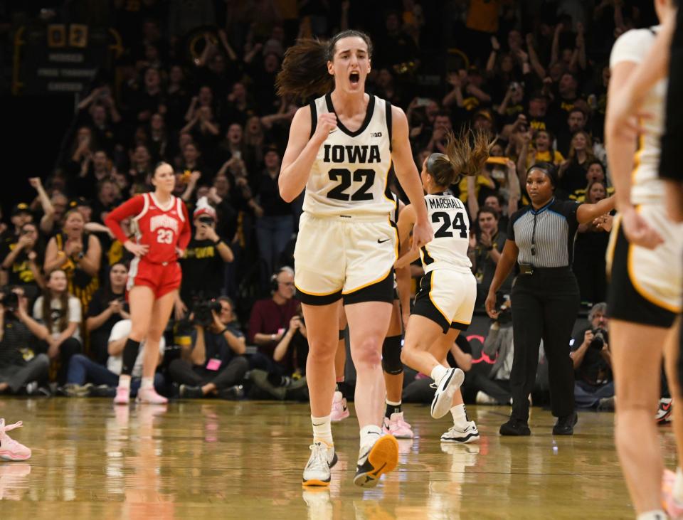 Iowa's Caitlin Clark celebrates after becoming the all-time leading scorer in NCAA Division I basketball on Sunday.