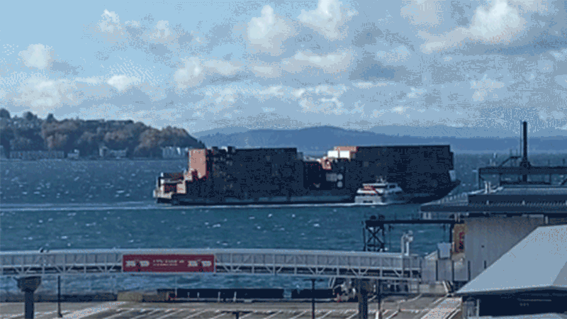 A gif showing a water taxi pushing a barge out to sea. 