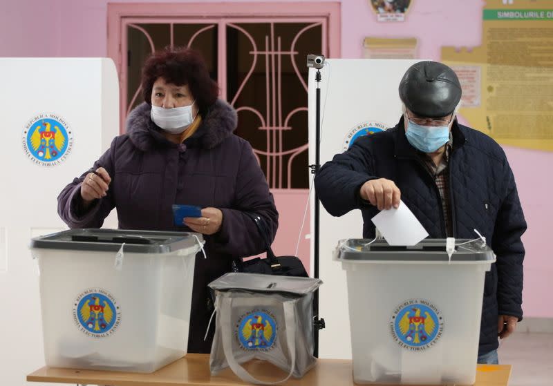 People cast their ballots at a polling station during the second round of a presidential election in Chisinau