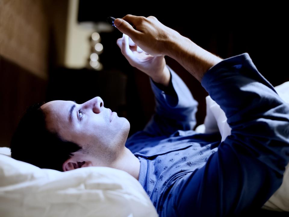 on phone in bed