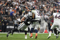 Las Vegas Raiders defensive end Chandler Jones (55) hurries Denver Broncos quarterback Russell Wilson (3) during the second half of an NFL football game, Sunday, Oct. 2, 2022, in Las Vegas. (AP Photo/David Becker)