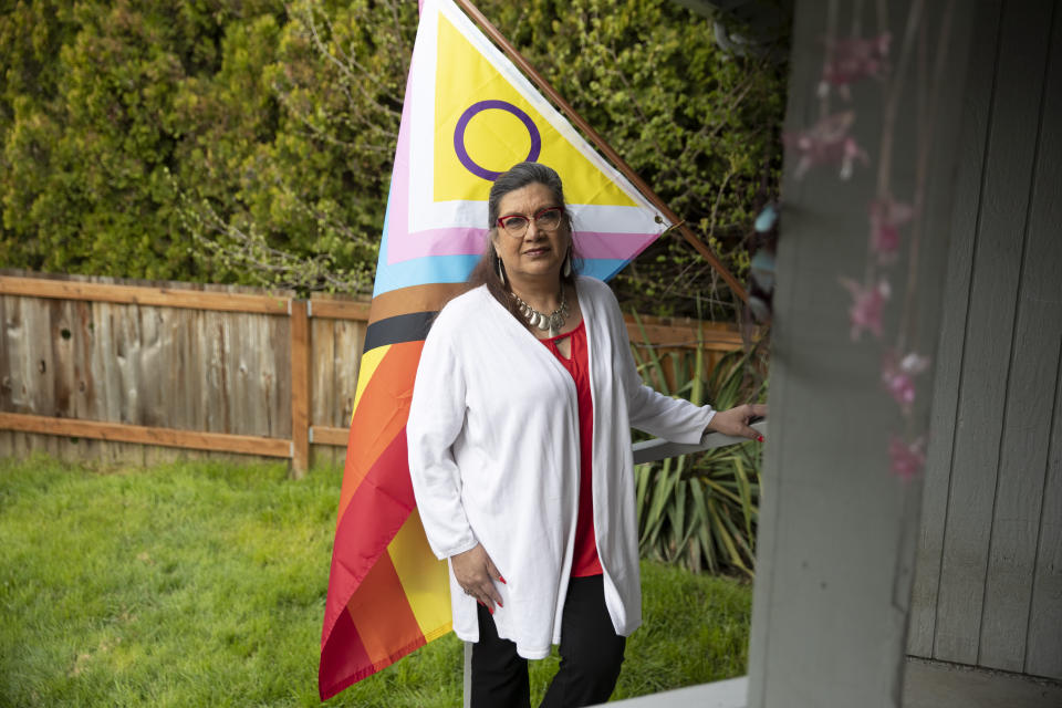 Christina Wood stands for a portrait at her home in Salem, Ore., Friday, April 21, 2023. For most of her life in New Mexico, Christina Wood felt like she had to hide her identity as a transgender woman. So six years ago she moved to Oregon, where she could access the gender-affirming health care she needed to live as her authentic self. (AP Photo/Amanda Loman)