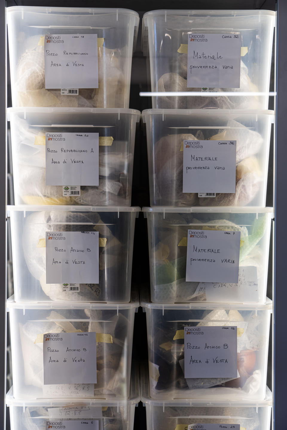 Archaelogical findings are stored in plastic tubs in the antiquities storeroom inside the Roman Forum in Rome, Wednesday, April 19, 2023. The pieces today on display at the Forum were part of the myriads of findings still kept in the Colosseum storehouse that is not open to the public. (AP Photo/Domenico Stinellis)