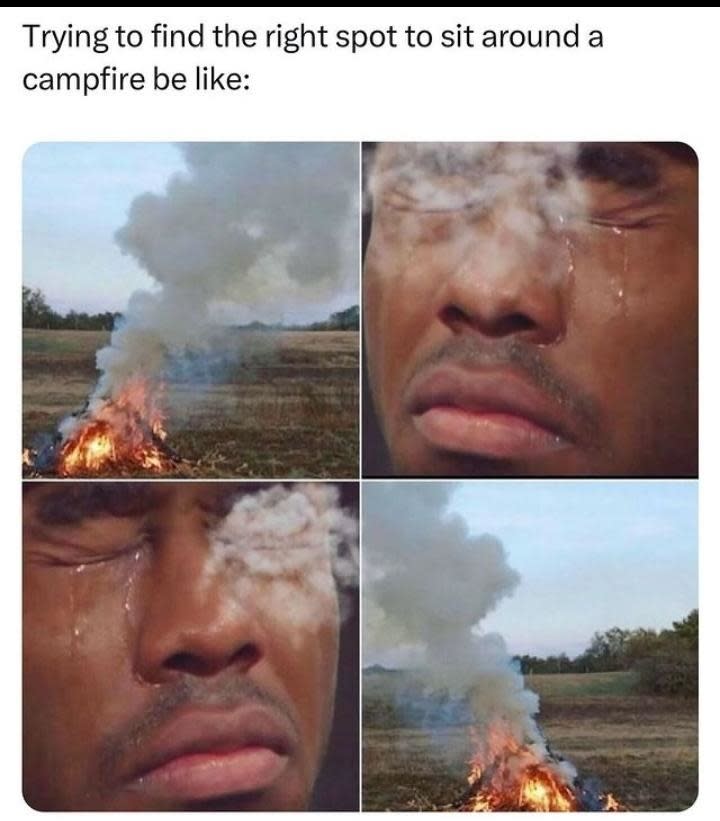 Four-panel meme: Person squinting and tearing up while smoke from a campfire blows into their face. Caption reads: "Trying to find the right spot to sit around a campfire be like:"