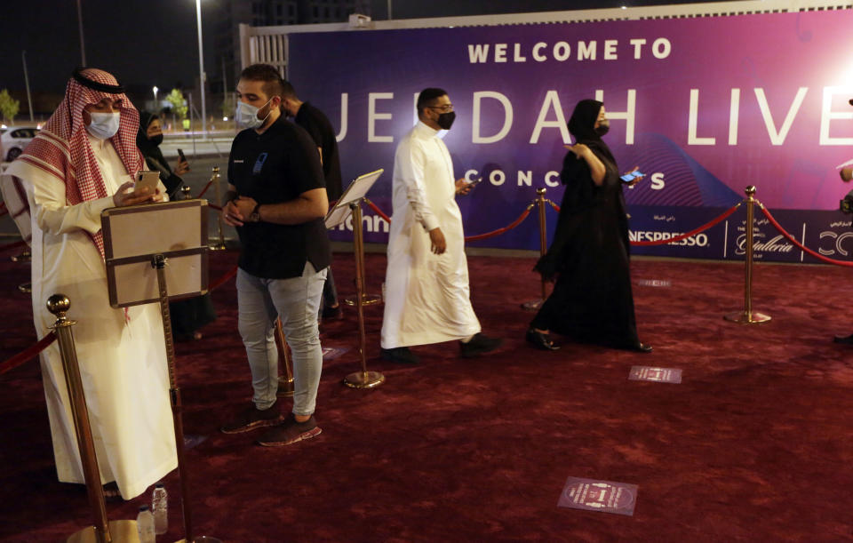 Saudi audience show their coronavirus vaccine online certificate as they enter the concert of prominent Saudi singer Mohammed Abdu at the newly built Super Dome, in Jiddah, Saudi Arabia, late Thursday, July 8, 2021. In the two decades since Sept. 11, 2001, Saudi Arabia has confronted al-Qaida on its own soil, revamped its textbooks, worked to curb terror financing and partnered with the United States to counter terrorism. (AP Photo/Amr Nabil)
