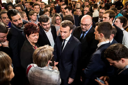 French President Emmanuel Macron (C) discusses with guests next to French President of the Young Farmers Association Jeremy Decerle (on his left) and French Agriculture Minister French Agriculture Minister Stephane Travert (on his right) after he delivered a speech to the young French farmers invited at the Elysee Palace before the opening of the 2018 Paris International Agricultural Show in Paris, France, February 22, 2018. REUTERS/Etienne Laurent/Pool