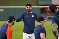 Houston Astros' Jose Altuve smiles as he talks with teammate as the start of a baseball practice in Houston, Thursday, Oct. 14, 2021. The Astros host the Boston Red Sox in Game 1 of the American League Championship Series on Friday. (AP Photo/Tony Gutierrez)