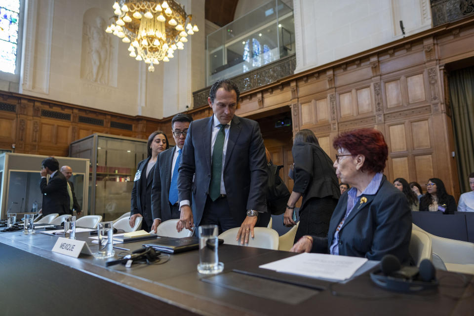 Mexico's agent and ambassador Carmen Moreno Toscano, right, and legal advisor Alejandro Celorio Alcantar, center, wait for judges to enter the International Court of Justice in The Hague, Netherlands, Tuesday, April 30, 2024, where Mexico is taking Ecuador to the United Nations' top court accusing the nation of violating international law by storming into the Mexican embassy in Quito and arresting former Ecuador Vice President Jorge Glas, who had been holed up there seeking asylum in Mexico. (AP Photo/Peter Dejong)