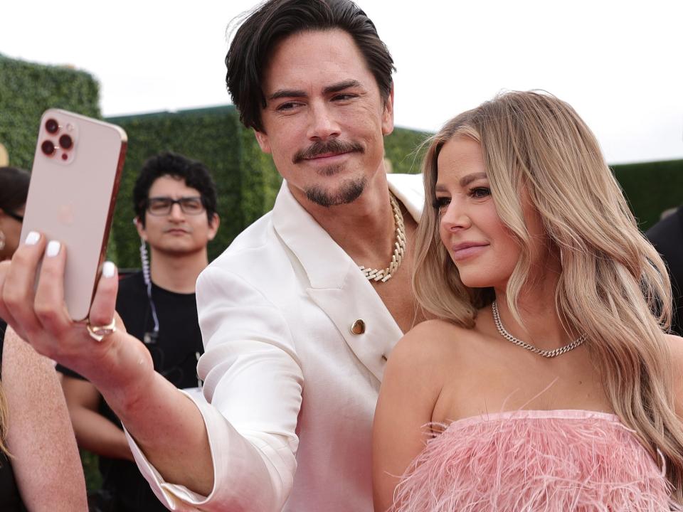 Tom Sandoval and Ariana Madix taking a selfie on the red carpet of the MTV Movie & TV Awards.