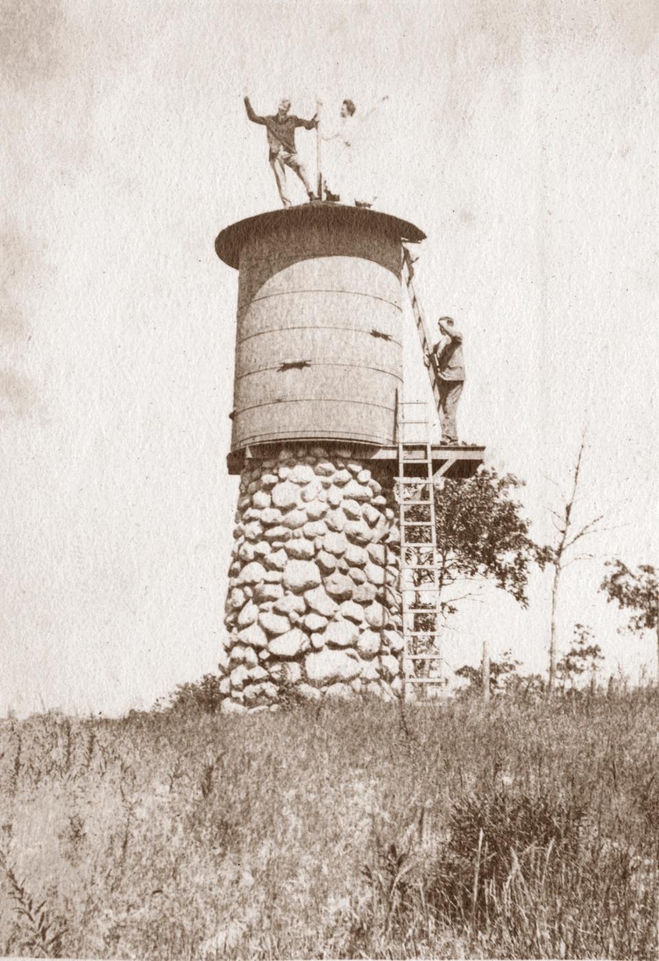 The original water tower, made of native stone and a cypress barrel and platform, still stands on the Davis-Douglas Farm in Plymouth. In this circa 1904 photo, Hester Davis, the oldest daughter of Howland Davis, has climbed to the roof with a friend and can see Long Pond nearby. More than 100 years later, her great-granddaughter, also named Hester, would re-create the climb with Sam Chapin.