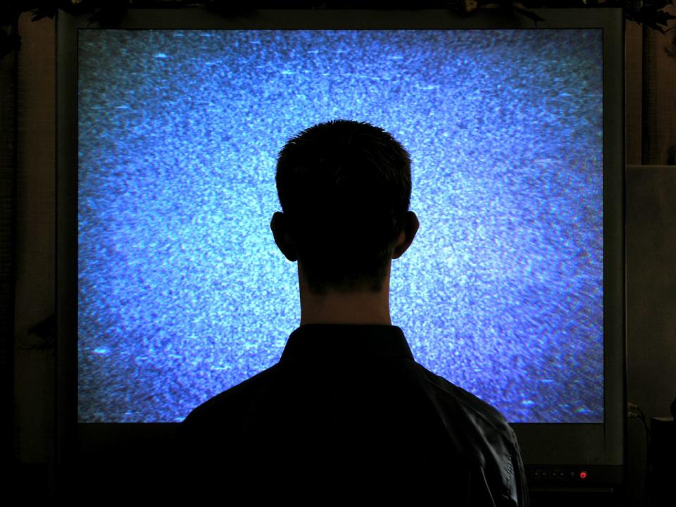 man watches static tv