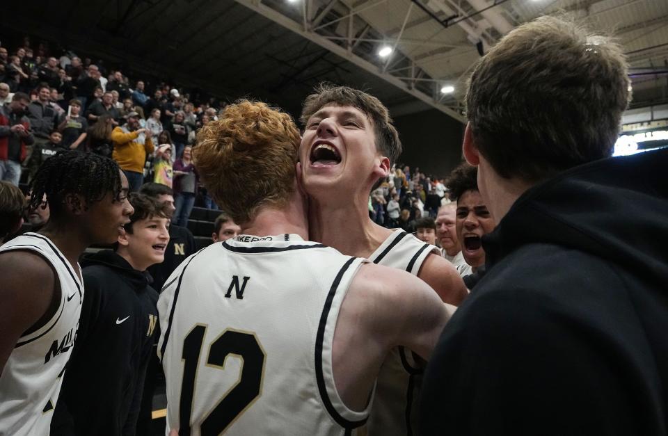 Noblesville Millers forward Cooper Bean (5) yells in excitement after defeating the Carmel Greyhounds in a buzzer three point shot Friday, Dec. 9, 2022 at Noblesville High School in Noblesville. Noblesville Millers defeated the Carmel Greyhounds, 45-42. 
