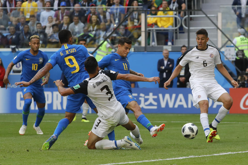 Brazil’s Philippe Coutinho stabs home the first goal of the game (AP)