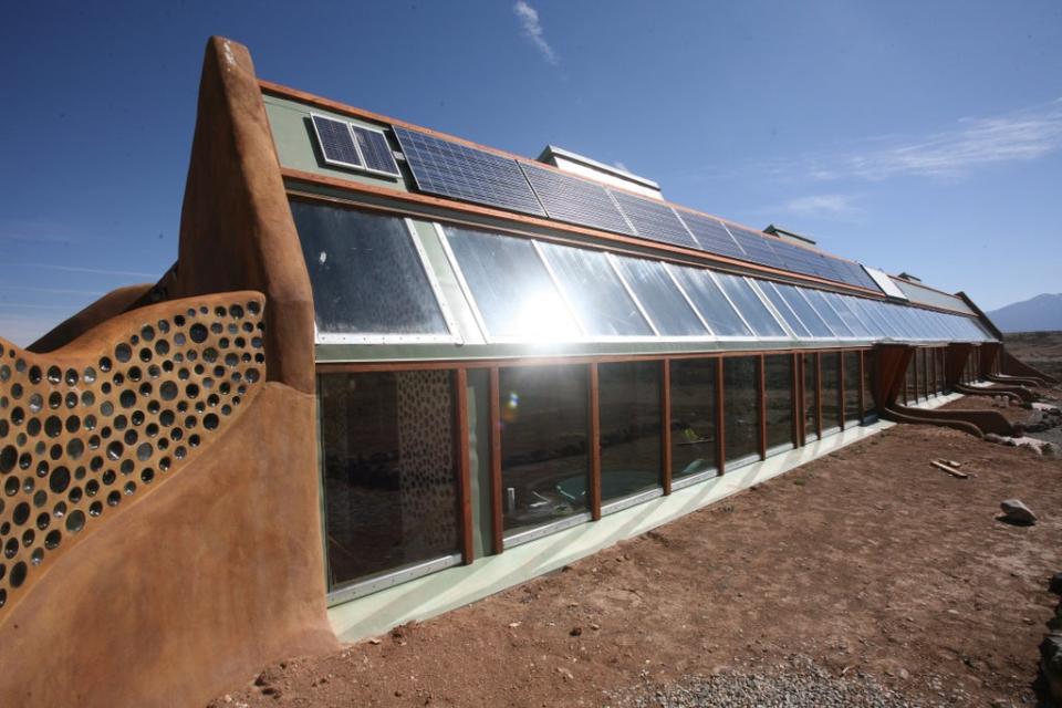 Solar panels provide much of the energy (Earthship Biotecture)