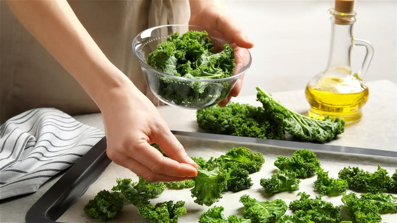 Placing kale on baking sheet 