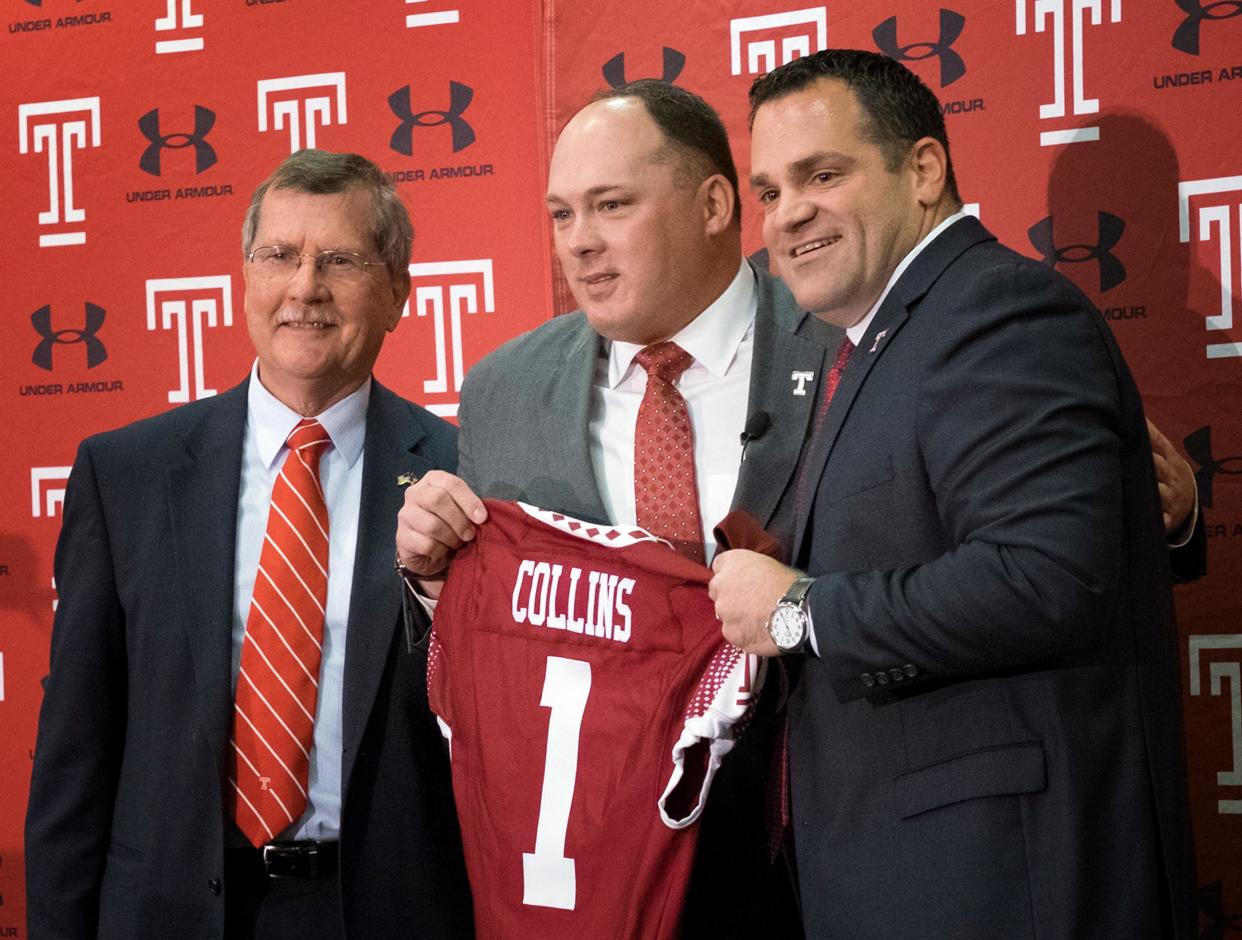 FILE - In this Dec. 14, 2016, file photo, Geoff Collins, center, stands between Temple University president Richard Englert, left, and athletic director Pat Kraft, during an NCAA college football news conference in Philadelphia, where Collins was introduced as Temple's new head football coach. Collins, former Florida defensive coordinator, has brought swag and Nick Saban structure to Temple. (Ed Hille/The Philadelphia Inquirer via AP)