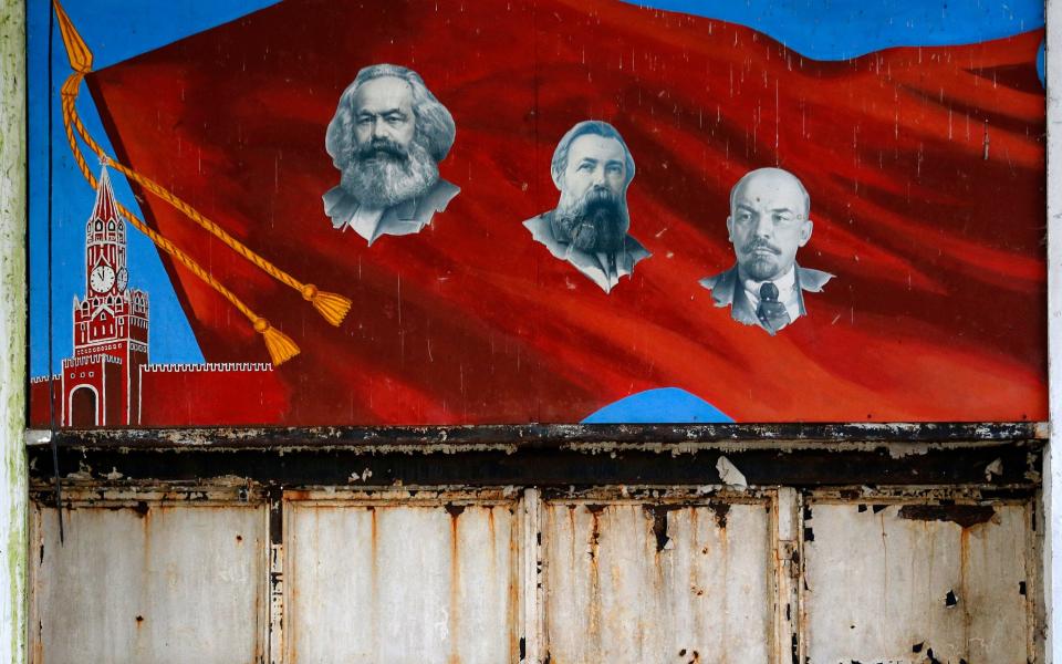 Communist icons, from left, Karl Marx, Friedrich Engels and Vladimir Lenin - Copyright 2017 The Associated Press. All rights reserved.