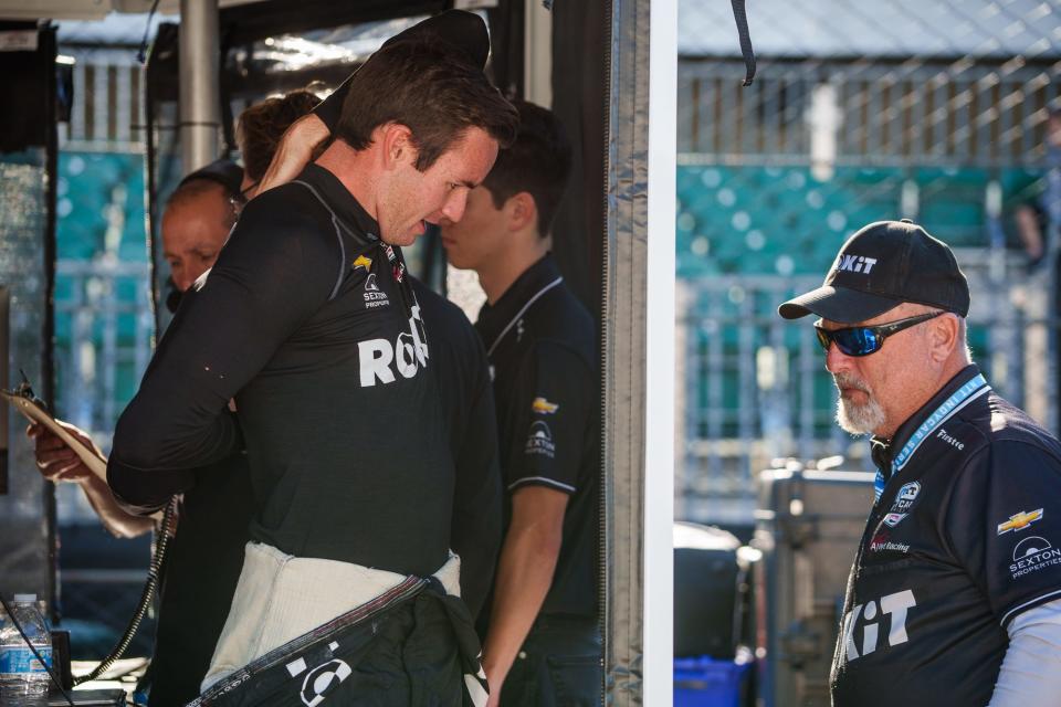 A. J. Foyt Enterprises driver Kyle Kirkwood (14) stretches Friday, May 13, 2022, prior to the first practice session for the GMR Grand Prix at Indianapolis Motor Speedway.