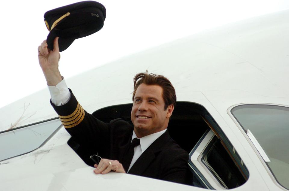 Qantas ambassador John Travolta waves from the cockpit of the Airbus A380 at Brisbane International Airport on Nov. 15 2005, before the plane flew over the city.