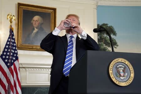 U.S. President Donald Trump takes a drink of water as he speaks about his recent trip to Asia in the Diplomatic Room of the White House in Washington, U.S., November 15, 2017. REUTERS/Joshua Roberts