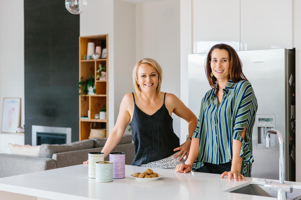 Franjos co-founder Jo Clark and Fran Woods stand behind a kitchen benchtop.