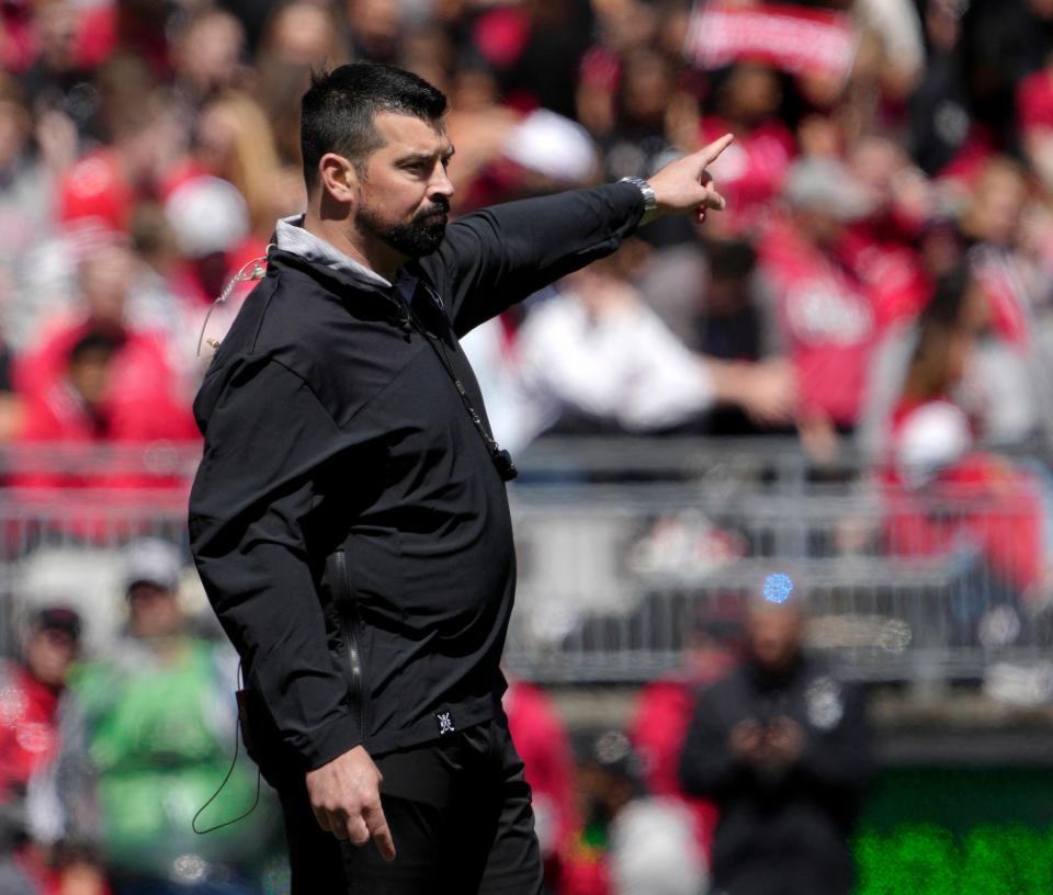 April 13, 2024; Columbus, Ohio, USA; 
Ohio State head football coach Ryan Day speaks to players during the first half of the LifeSports spring football game at Ohio Stadium on Saturday.