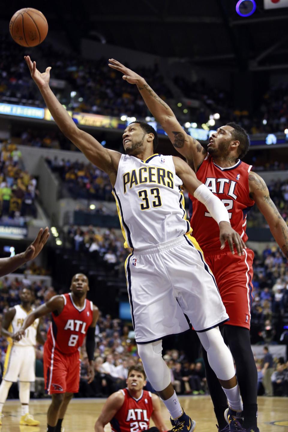 Indiana Pacers forward Danny Granger (33) puts up a shot while guarded by Atlanta Hawks forward Mike Scott during the second half of an NBA basketball game in Indianapolis, Tuesday, Feb. 18, 2014. (AP Photo/R Brent Smith)