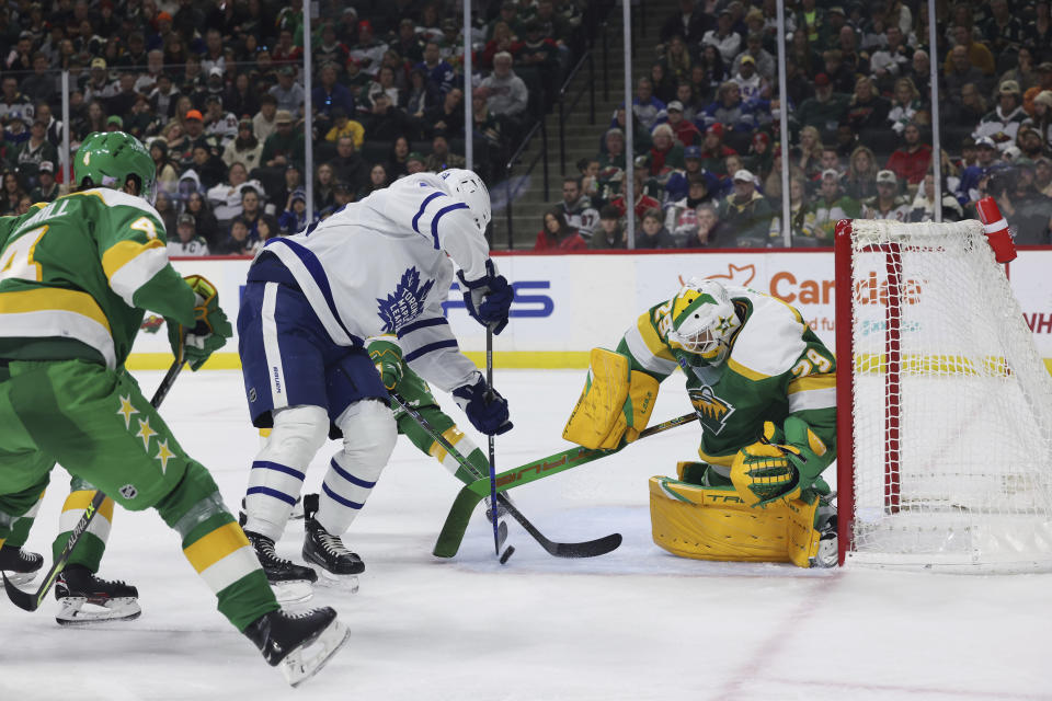 Toronto Maple Leafs center David Kampf (64) tries to score a goal against Minnesota Wild goaltender Marc-Andre Fleury (29) during the second period of an NHL hockey game Friday, Nov. 25, 2022, in St. Paul, Minn. (AP Photo/Stacy Bengs)