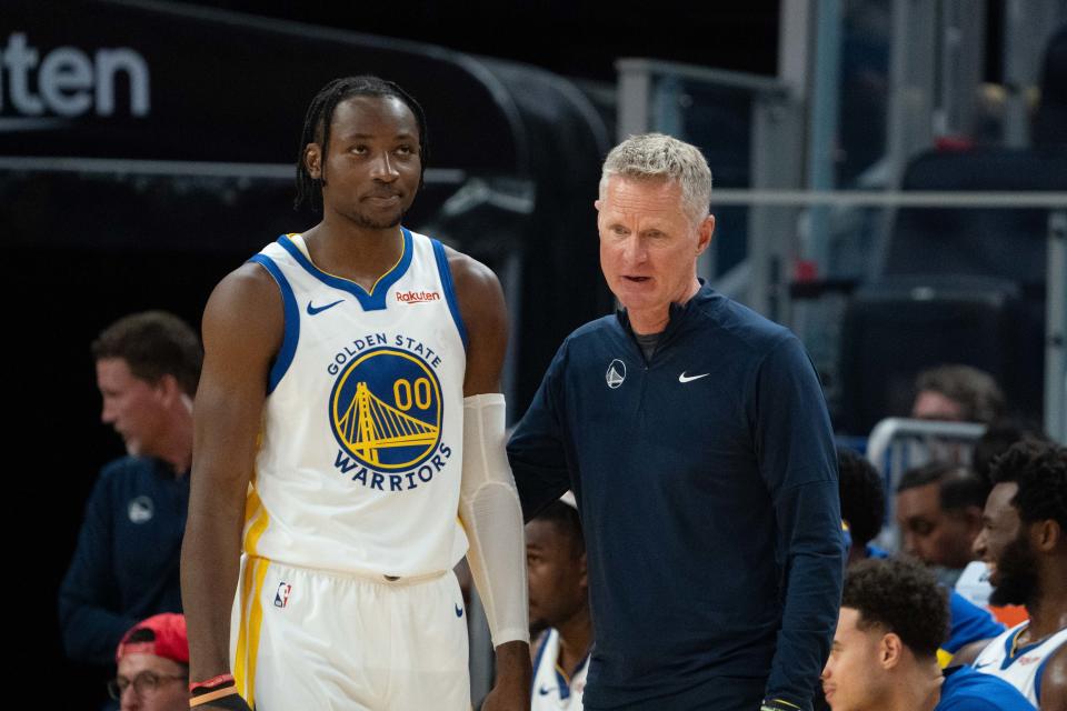 October 20, 2023; San Francisco, California, USA; Golden State Warriors head coach Steve Kerr (right) talks to forward Jonathan Kuminga (00) during the third quarter against the San Antonio Spurs at Chase Center. Mandatory Credit: Kyle Terada-USA TODAY Sports