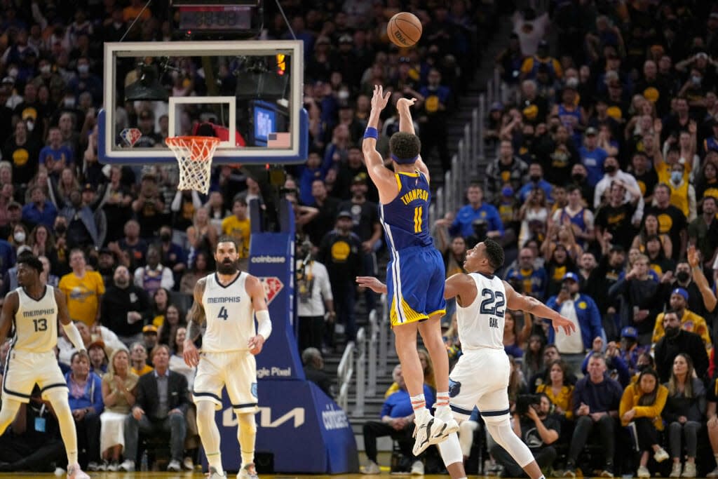 Golden State Warriors guard Klay Thompson (11) takes a 3-point shot over Memphis Grizzlies guard Desmond Bane (22) during the second half of Game 6 of an NBA basketball Western Conference playoff semifinal in San Francisco, Friday, May 13, 2022. The Warriors won 110-96 and advanced to the conference finals. (AP Photo/Tony Avelar)