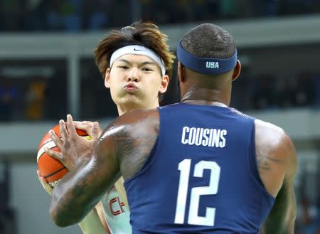 Wang Zhelin (CHN) of China (PRC) and DeMarcus Cousins (USA) of the USA in action. REUTERS/Lucy Nicholson