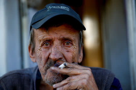 Bosnian Serb Nedjeljko Matic, an internally displaced person from Donji Vakuf, poses for a photograph in front of his house at a reception center where IDPs live, in Bratunac, Bosnia and Herzegovina, September 28, 2018. REUTERS/Dado Ruvic