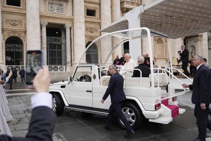 Pope Francis waves as he arrives for his weekly general audience in St. Peter's Square at The Vatican, Wednesday, May 17, 2023. (AP Photo/Andrew Medichini)