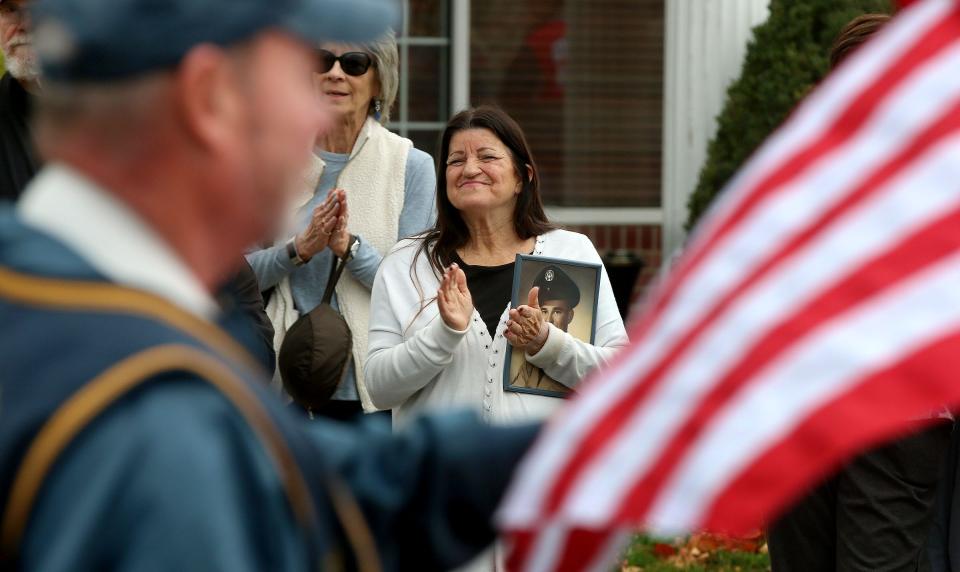 Janet Fox, Toms River, holds a picture of her father and Korean War Veteran Frank Applegate on Washington Street as the Toms River Veteran's Day Parade marched past Friday, November 11, 2022.