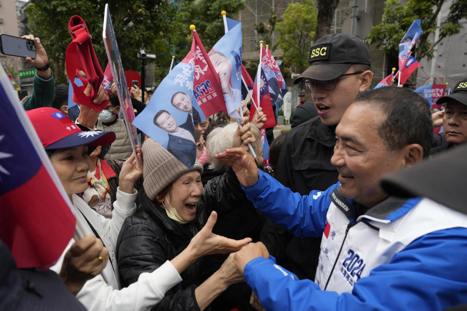 FILE - Taiwan's Nationalist Party presidential candidate Hou Yu-ih is greeted by residents as he canvass a neighborhood in Taipei, Taiwan, on Jan. 9, 2024. Taiwan holds presidential and parliamentary elections Saturday that China has described as a choice between war and peace. Hou is the candidate from Taiwan's main opposition party Kuomintang, or KMT, whose government retreated to the island in 1949 after losing a civil war against the Chinese Communist Party. (AP Photo/Ng Han Guan, File)